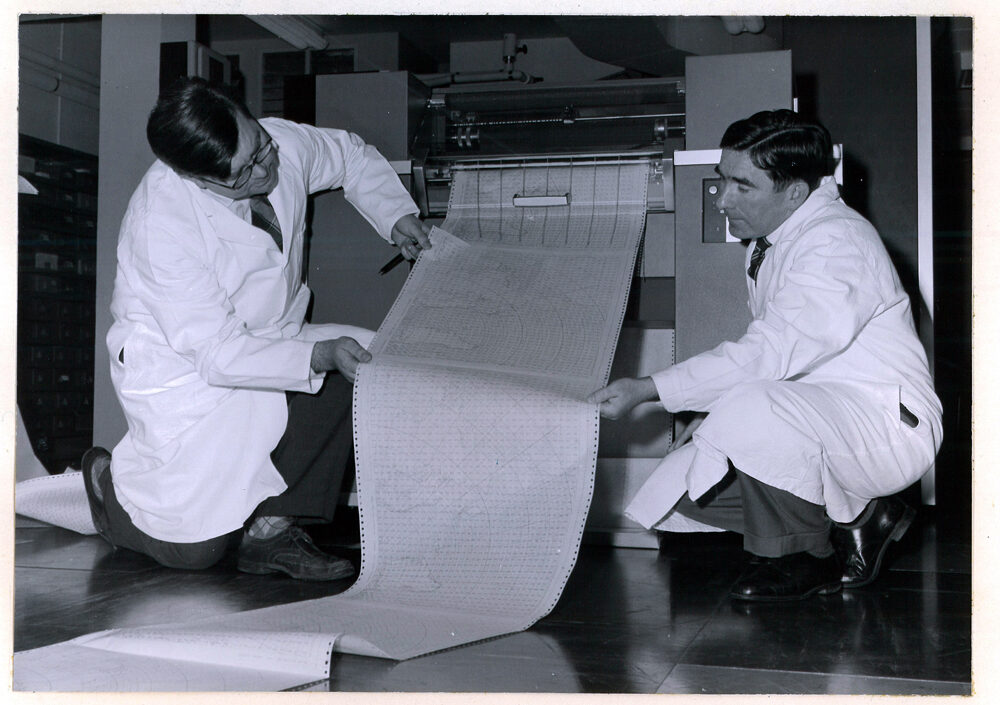 Two meteoroligists with a KDF9 Computer Installation - Close-up of line printer showing output from a numerical forecast program