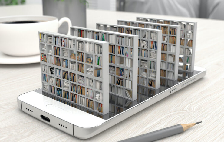 Bookcase with books on a smartphone screen on a desktop. 